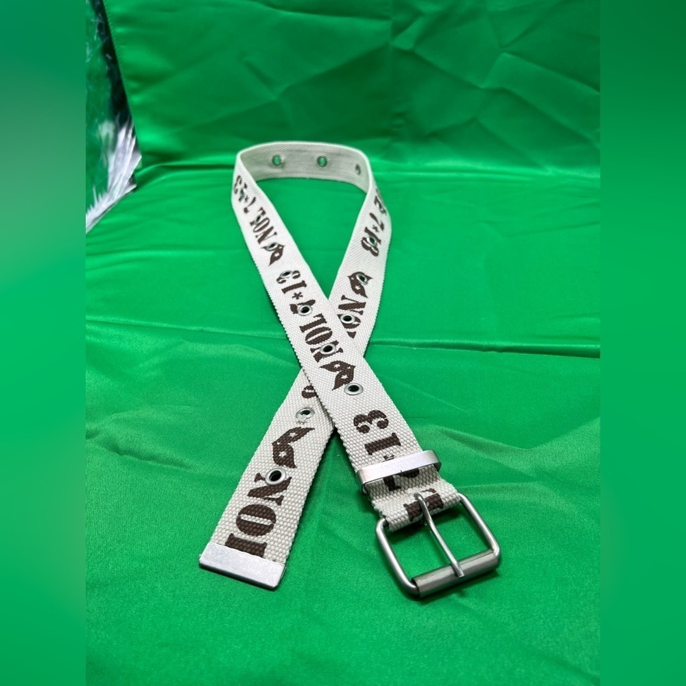 Cream color canvas belt with greenish brown lettering